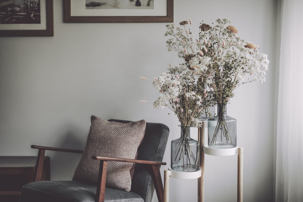Reading corner with chair, books and lamp in a modern interior, representing property management and landlord guidance